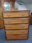 A 20th century five-drawer chest with matching three-drawer chest and pair of two-drawer bedside