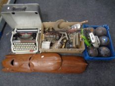 A box of metal wares and a Brother manual typewriter, lawn bowls, die cast cars,