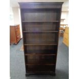 A set of open bookshelves in an oak finish