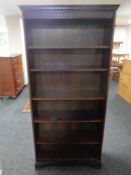 A set of open bookshelves in an oak finish