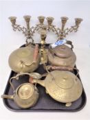 A tray of antique and later brass ware including teapots, pair of candlesticks,