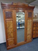 A 19th century mahogany and walnut three piece bedroom suite comprising of triple door wardrobe,