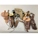 Five various Second World War and later leather and canvas holsters