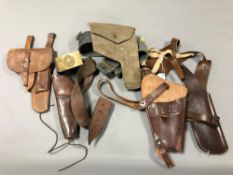 Five various Second World War and later leather and canvas holsters