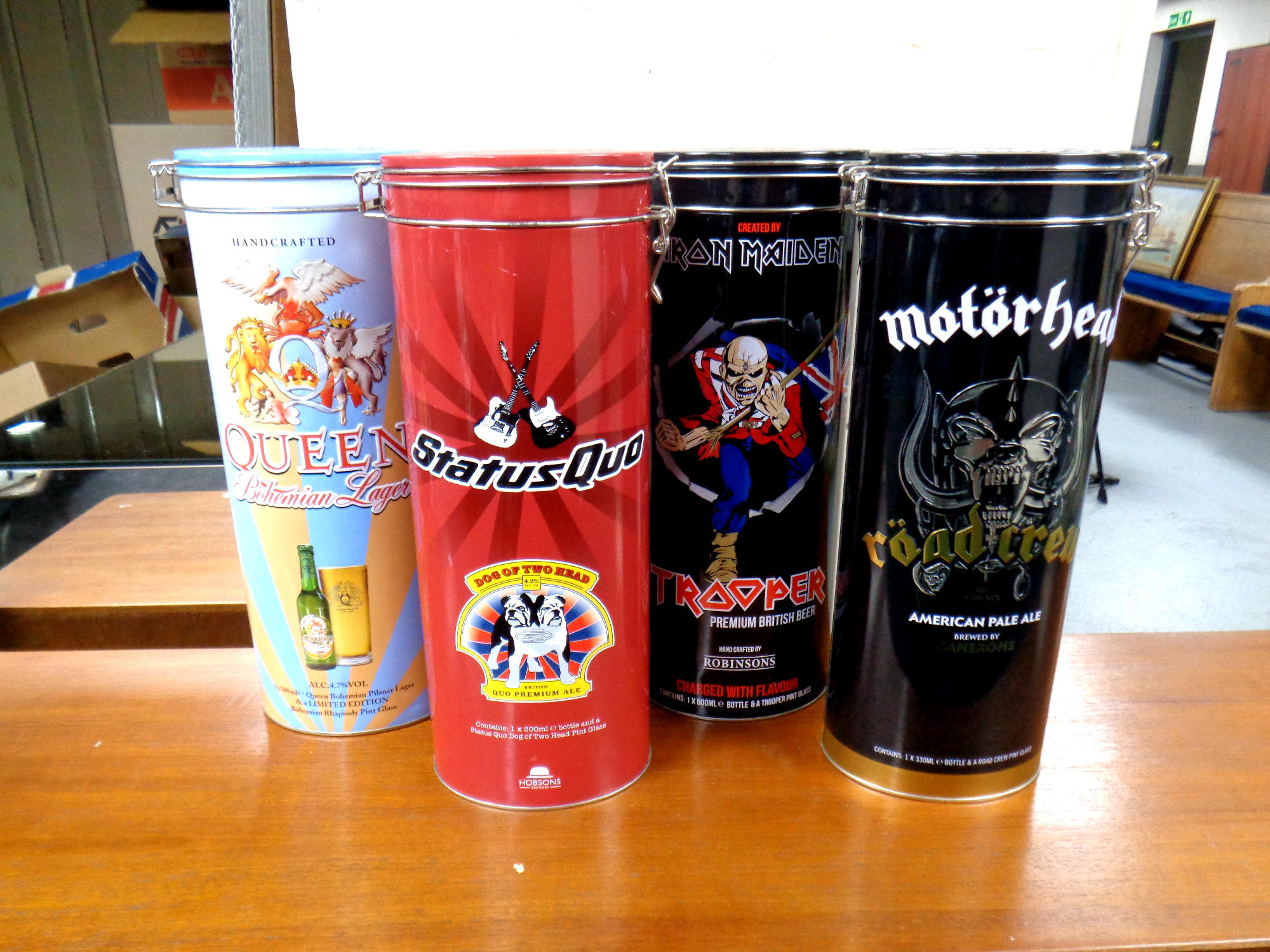 A group of four rock themed larger, beer and ale bottles - Iron Maiden, Queen,