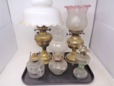 A tray of five assorted oil lamps, three with chimneys,