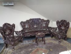 A four-piece Chinese hardwood mother of pearl inlaid lounge suite with carved dragon decoration,