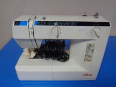 A Elna electric sewing machine with foot pedal