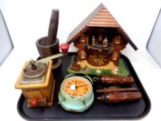 A tray of cuckoo clock, wood mortar and pestle, coffee grinder,