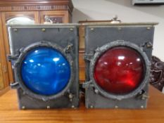 Two vintage railway signalling lamps with red and blue lenses