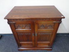A Priory Oak double door television cabinet