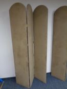 A three-way folding room divider upholstered in a brown beige fabric