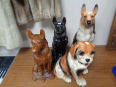 Four pottery fireside dog ornaments