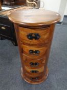 A sheesham wood cylindrical five drawer chest