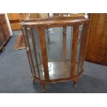 A 20th century walnut shaped front display cabinet