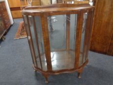 A 20th century walnut shaped front display cabinet