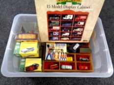 A box of two die cast model display stands, assorted boxed and un-boxed cars,