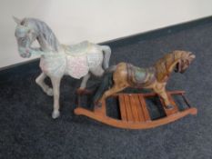 A miniature wooden rocking horse and a figure of a wooden horse