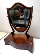 A George III shield shaped mahogany dressing table mirror