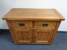 A contemporary oak double door cupboard fitted two drawers