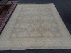 A Persian design carpet on beige ground,