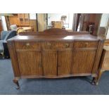 An Edwardian mahogany serpentine fronted sideboard