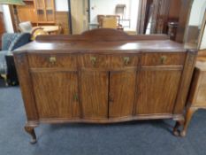 An Edwardian mahogany serpentine fronted sideboard