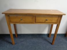 A contemporary oak two drawer side table