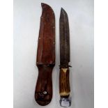 A Bowie style knife with antler grip in leather sheath
