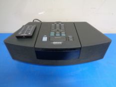 A Bose Wave radio/CD player with lead and remote