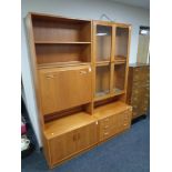 A 20th century teak G-Plan cocktail display unit fitted cupboards and drawers beneath