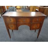 A mahogany bowfront sideboard on raised legs
