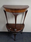 A walnut D-shaped hall table on claw and ball feet and a mahogany demi-lune turnover top card table