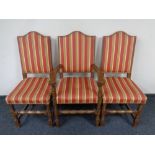 Eight oak high backed dining chairs upholstered in striped fabric