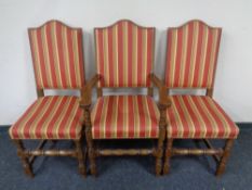 Eight oak high backed dining chairs upholstered in striped fabric