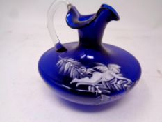 A 19th century Mary Gregory hand painted blue glass jug