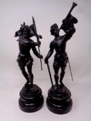 A pair of painted spelter figures on circular wooden bases