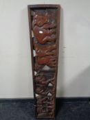 A 20th century African carved hardwood panel