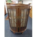 A walnut Chinoiserie bow fronted double door display cabinet