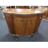 A 19th century inlaid mahogany shaped front cabinet on raised legs