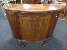 A 19th century inlaid mahogany shaped front cabinet on raised legs