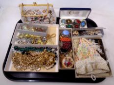 A tray of beadwork purse, costume jewellery, brooches,