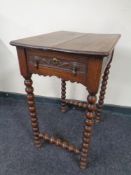 A 19th century carved oak occasional table fitted a drawer on bobbin legs