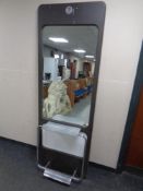 A hair dresser's floor standing mirror with footrest and shelf