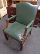 A Gainsborough style mahogany desk chair upholstered in a green studded leather
