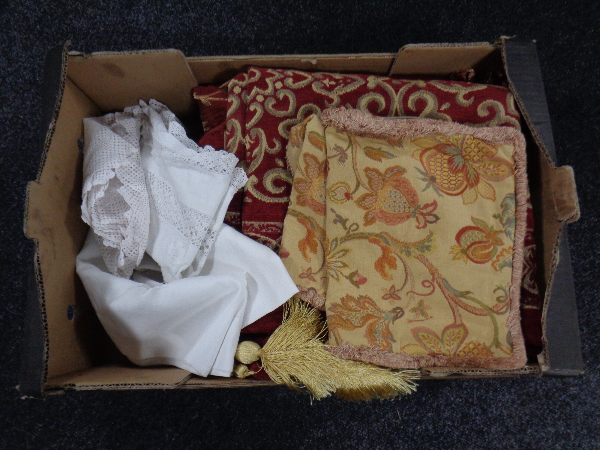 A box of cushion covers, linen,