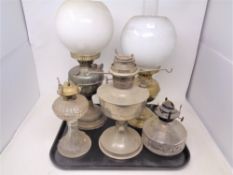 A tray of five assorted oil lamps to with chimneys and shades