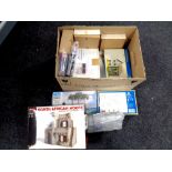 A box of unboxed and boxed diorama building modelling kits,