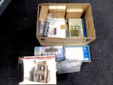 A box of unboxed and boxed diorama building modelling kits,