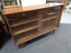 A set of mid 20th century teak sliding glass door bookshelves